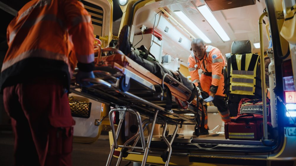 Emergency Care Assistants Transporting a patient on a stretcher for a flight