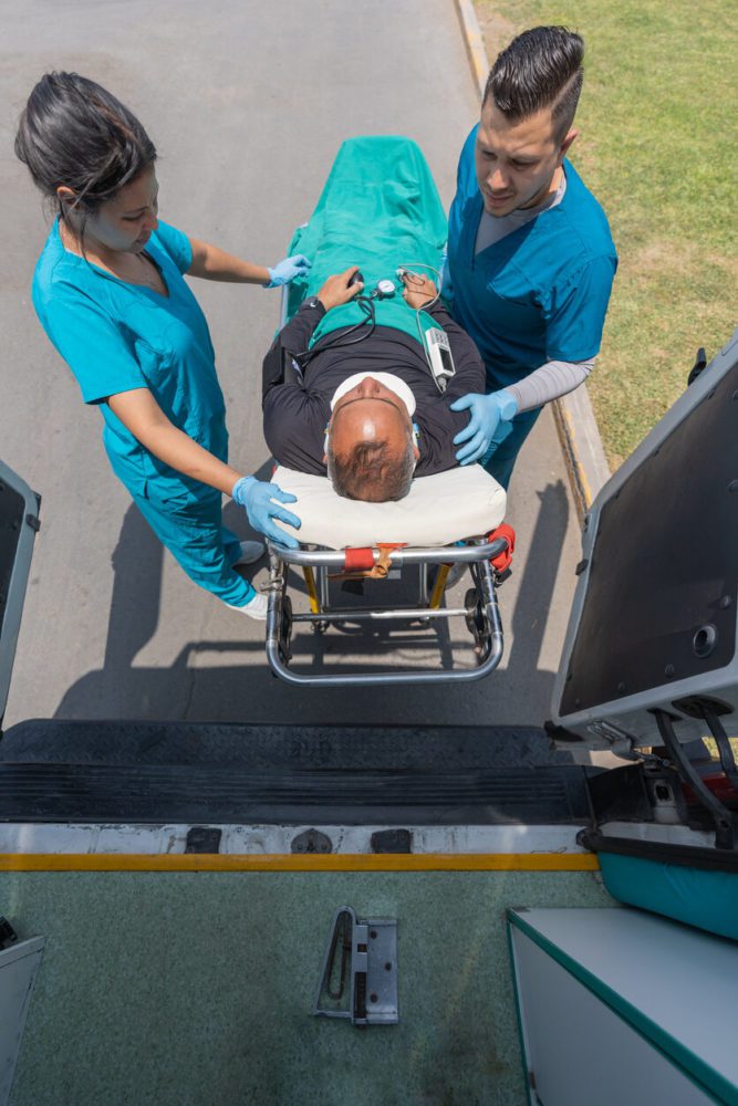 medical repatriation Service, Medical workers carrying a patient with a neck collar on a stretcher from an airplane