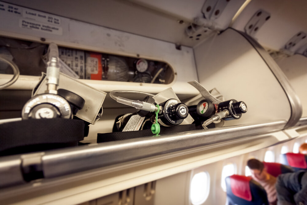 Flying With Medical Oxygen. Closeup View Of Oxygen Cylinders On Aircraft.
