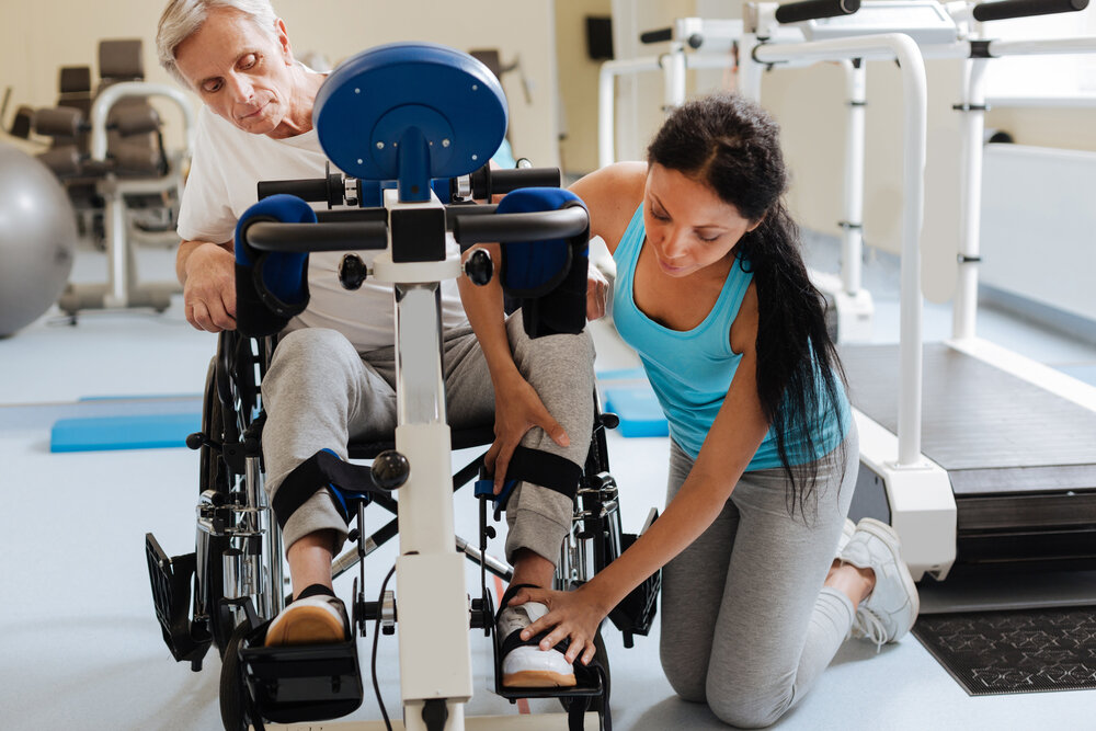 immobile elderly parent. Female professional helping patient